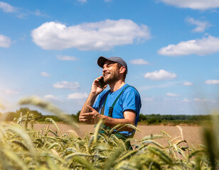 Person standing in a crop field speaking on a mobile phone