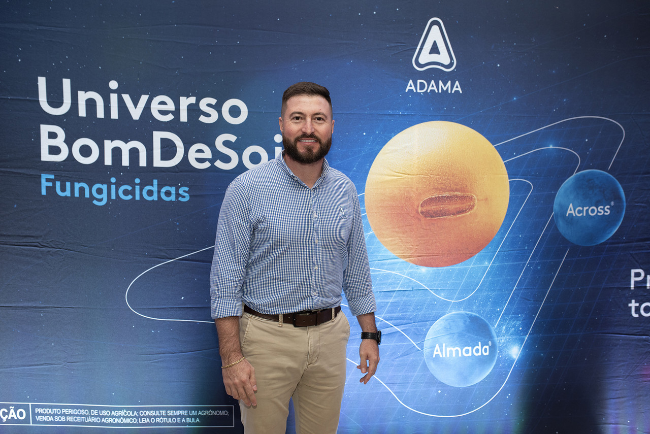 Gerente de fungicidas Eduardo Martinez em frente a um painel da campanha Universo Bom de Soja