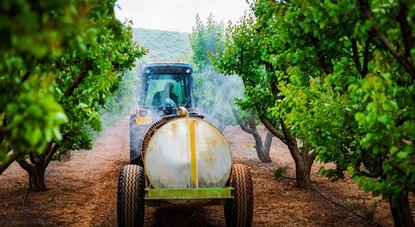 Farmer uses a crop sprayer.jpg