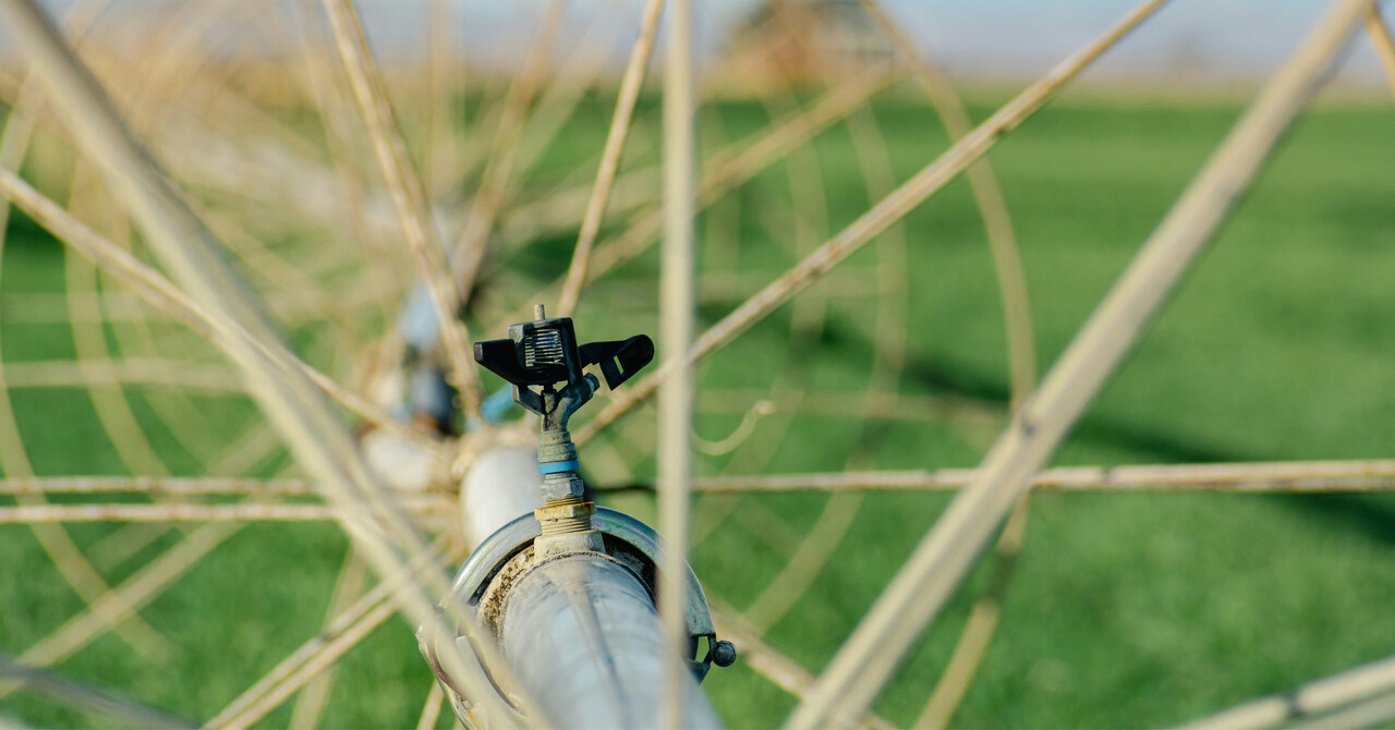 Close-up of an irrigation system sprinkler in a green field
