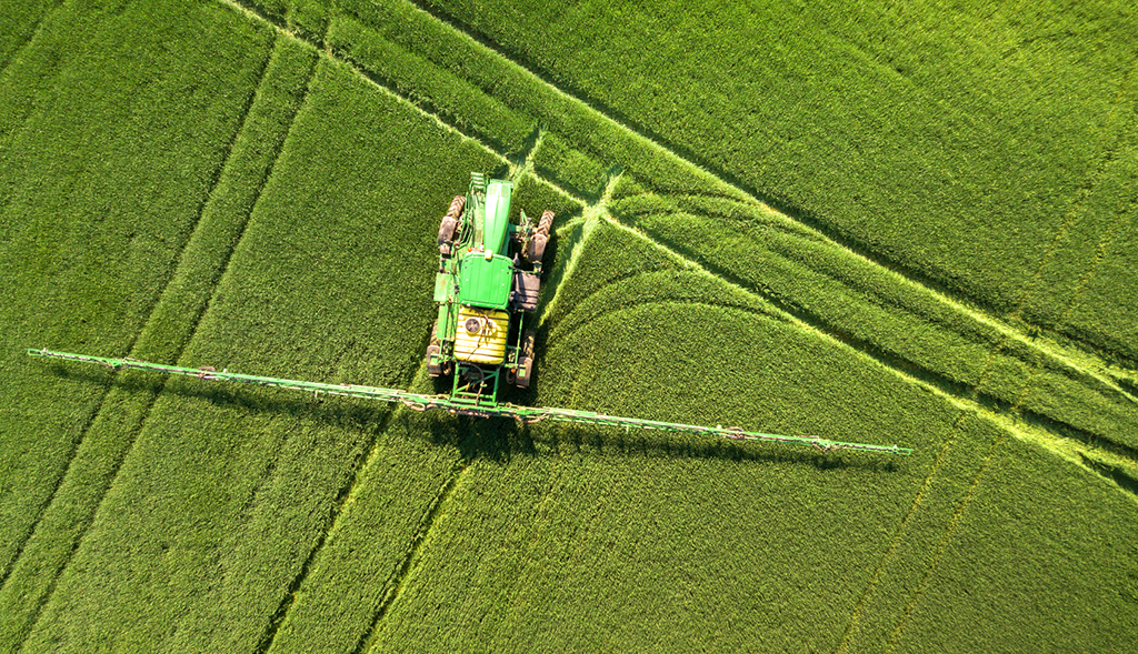 Sprayer with spray booms on field
