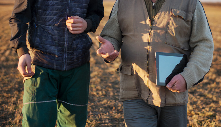 two growers talking in a field