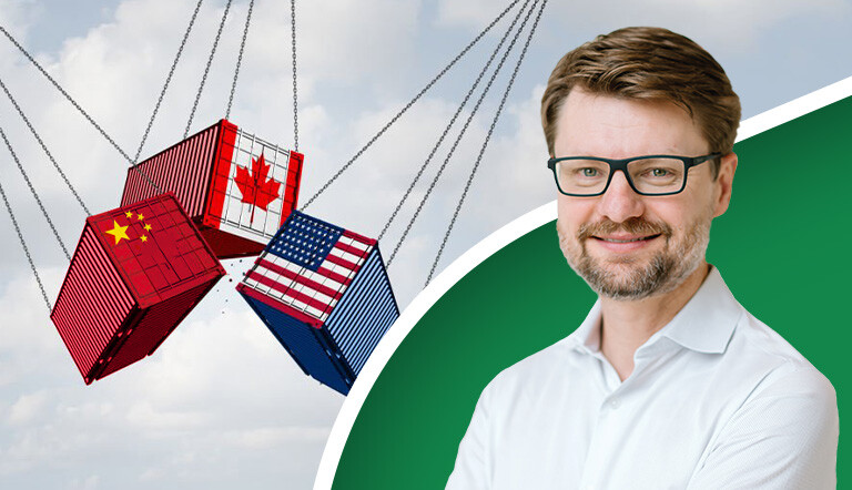 Shipping containers decorated in the USA, Canada, and China flag.