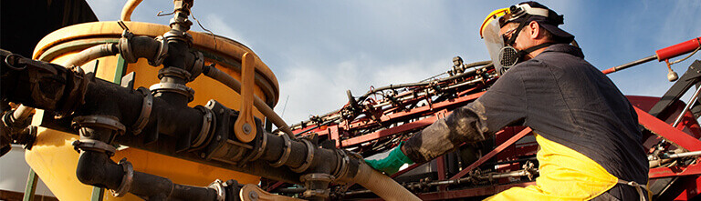 Man in PPE with sprayer