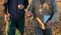 two growers talking in a field